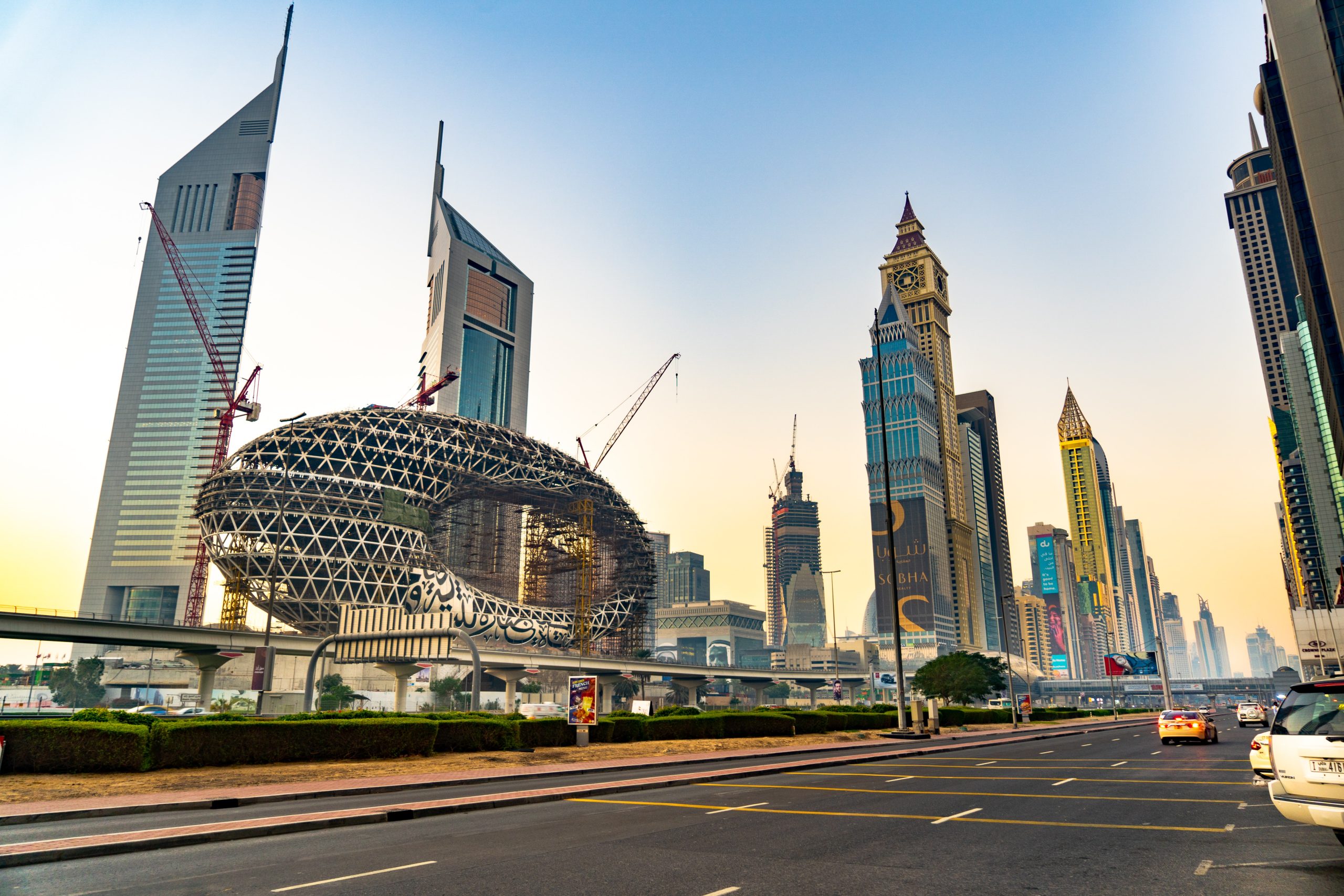 Museum of the Future under construction along Sheikh Zayed Road with Emirates Towers and Dubai skyline