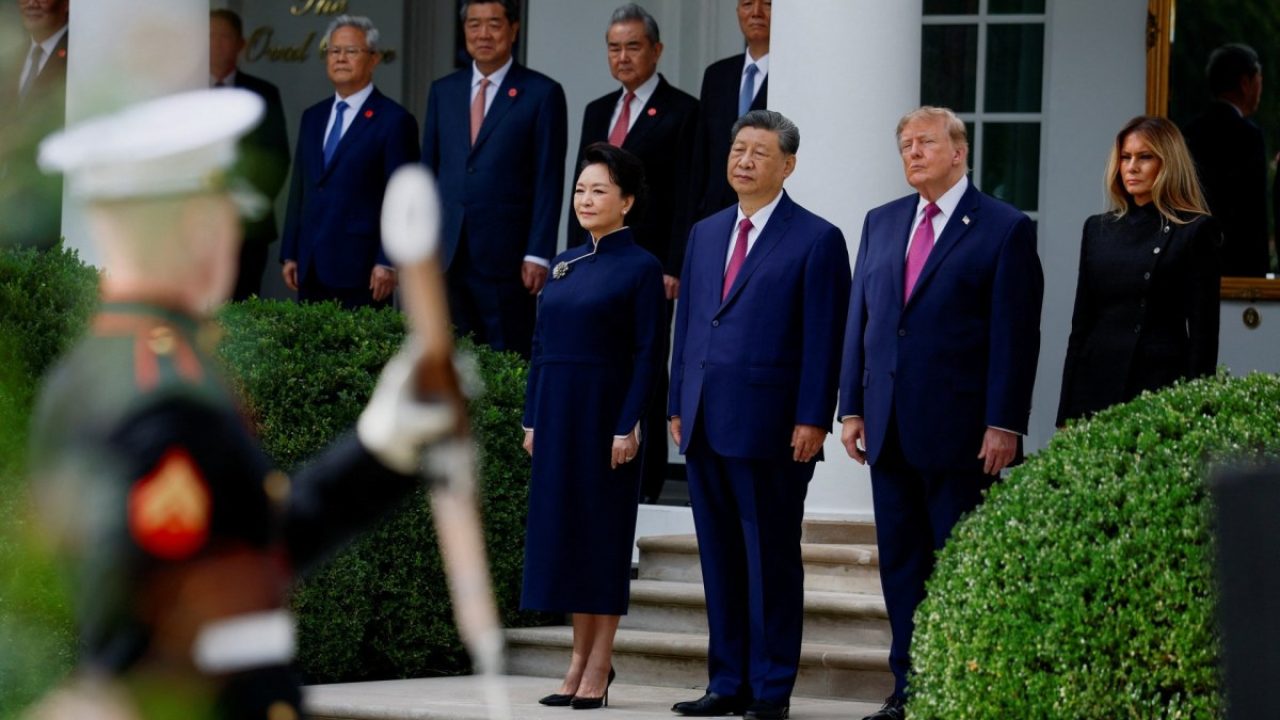 Xi Jinping and Donald Trump standing with their spouses during an official ceremony at the White House.