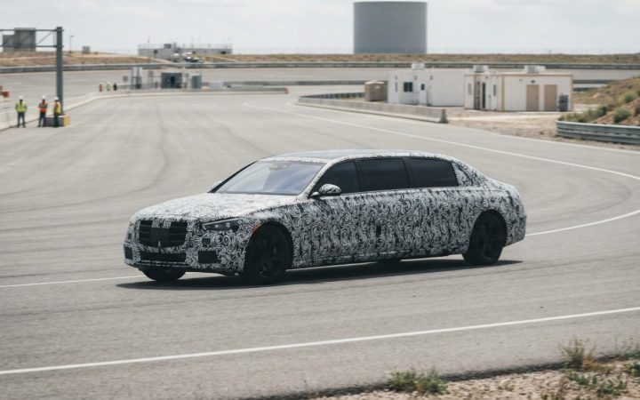 Illustration: A modern camouflaged full-size luxury executive limousine driving on an automotive proving ground test track under bright daylight, show