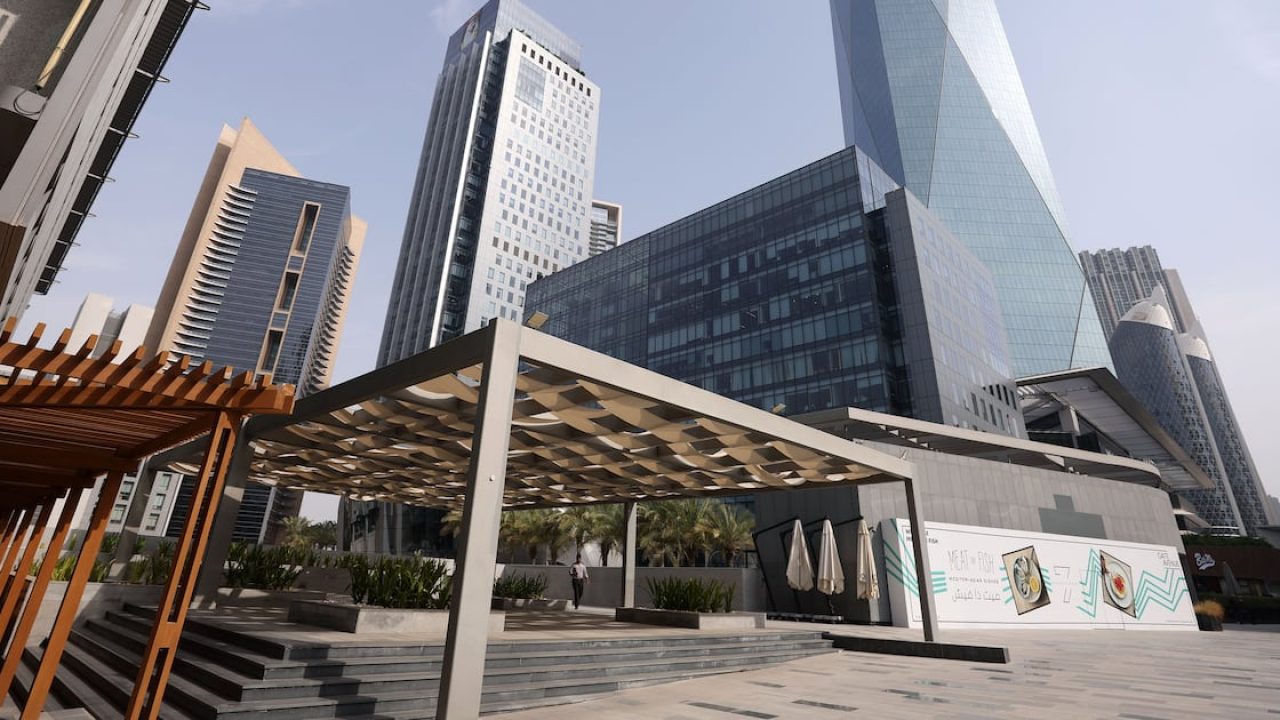 Modern office towers and shaded outdoor pedestrian terrace in a Dubai business district