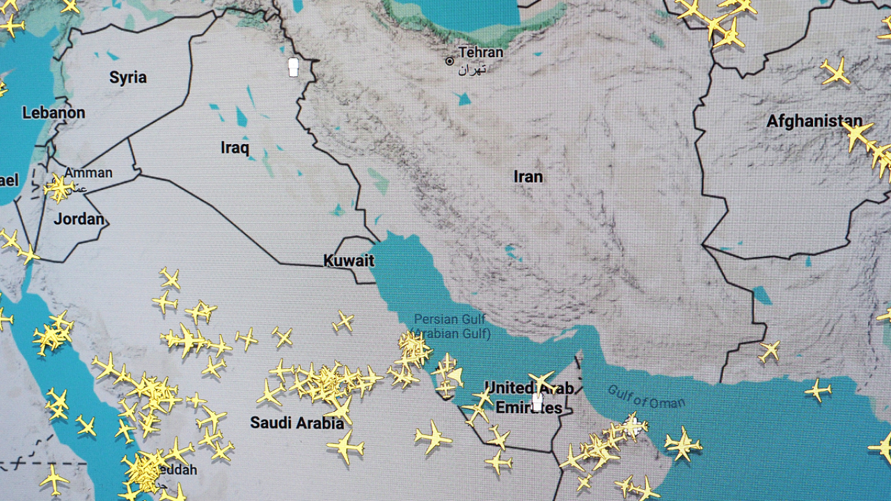 Flight tracking map displaying air traffic across the Middle East with empty airspace over Iran and Iraq