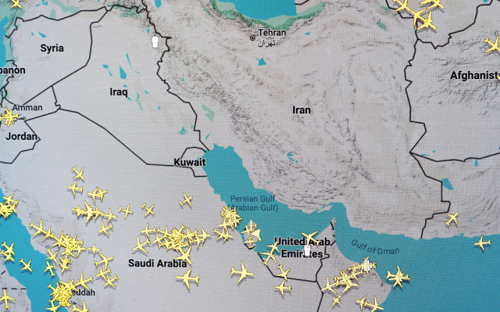 Flight tracking map displaying air traffic across the Middle East with empty airspace over Iran and Iraq