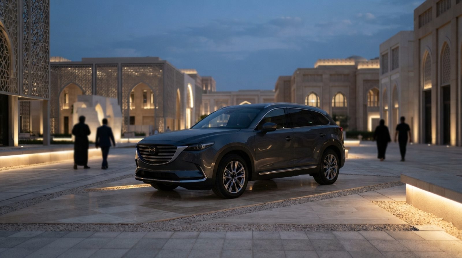 Illustration: Editorial news photograph showing a sleek modern premium SUV parked on an open outdoor exhibition pavilion in Abu Dhabi at dusk, illumin