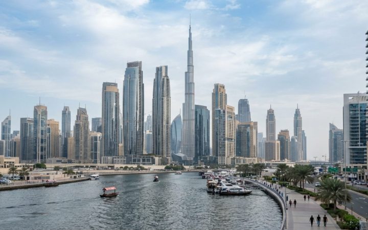 Illustration: Modern financial district skyline in Dubai with high-rise commercial towers and reflective glass architecture during daylight, neutral e