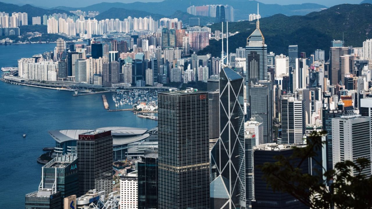 High-angle view of Hong Kong financial district skyscrapers and Victoria Harbour