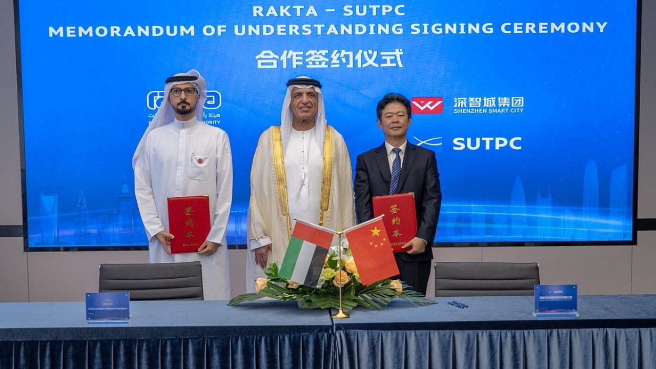 RAKTA and SUTPC representatives at an MoU signing ceremony with UAE and Chinese flags displayed