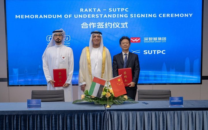 RAKTA and SUTPC representatives at an MoU signing ceremony with UAE and Chinese flags displayed