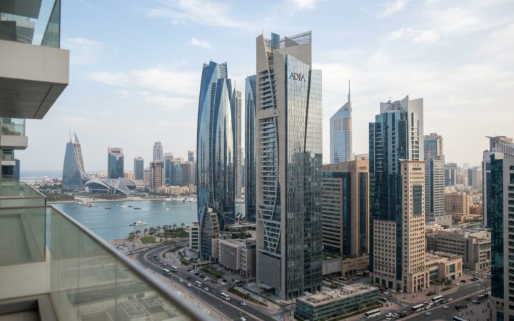 Illustration: Financial district skyscrapers in Abu Dhabi and Riyadh during daytime, featuring modern banking headquarters with glass facades reflecti
