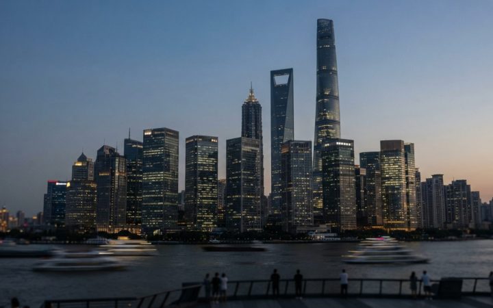 Illustration: Editorial photograph of high-rise financial district towers with illuminated glass facades against an evening sky, representing internat