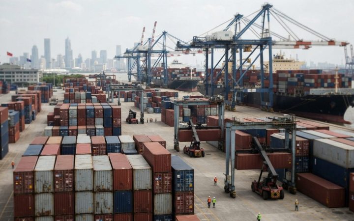 Illustration: A busy commercial container terminal with cargo ships, cranes, and stacked freight containers under daylight, representing international
