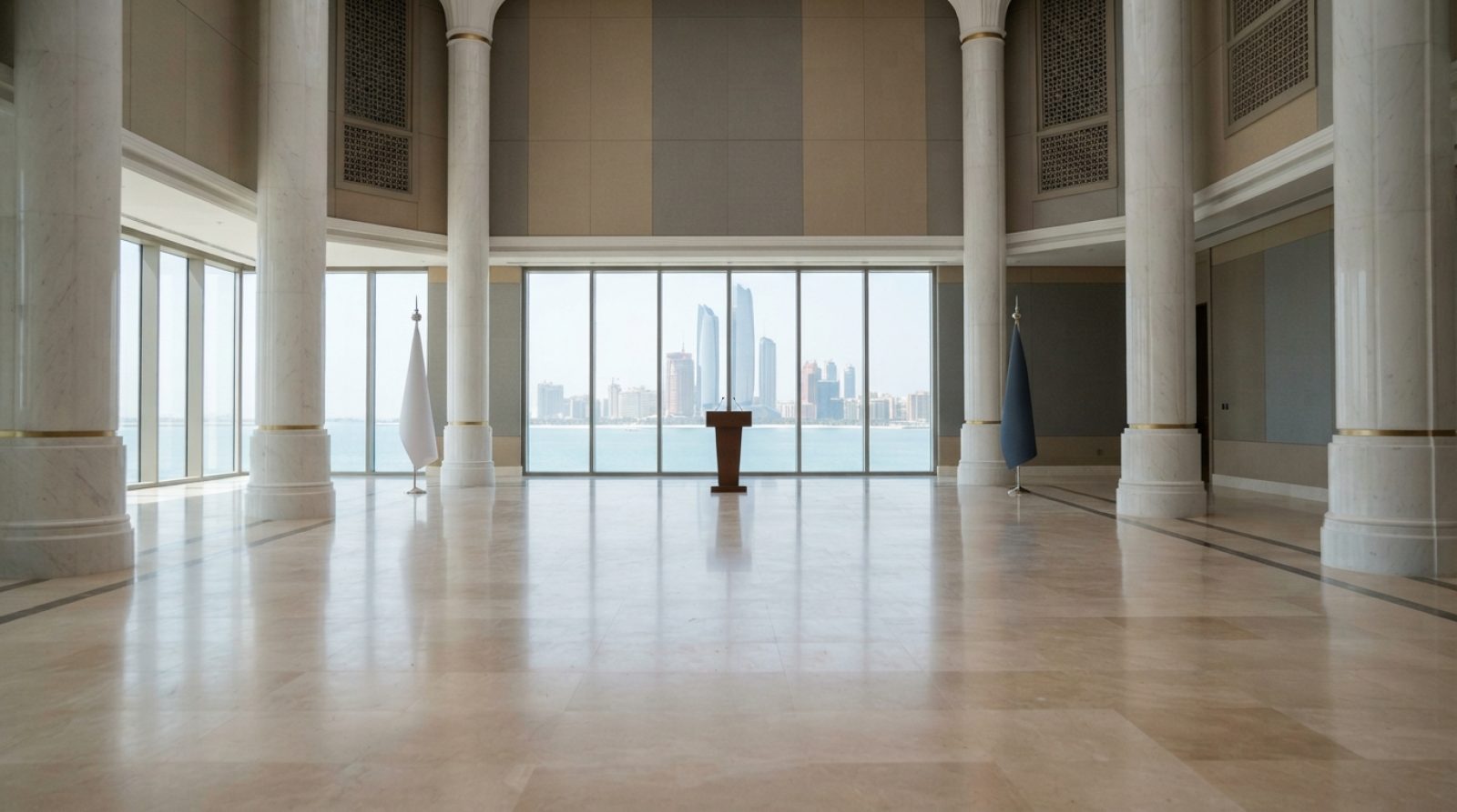 Illustration: A brightly lit, elegant diplomatic ceremonial hall in Abu Dhabi with grand marble columns, polished stone flooring, and expansive window