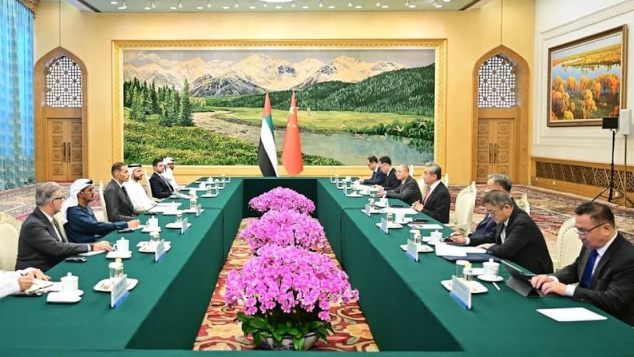 UAE and Chinese delegations seated at a formal conference table with national flags in the background