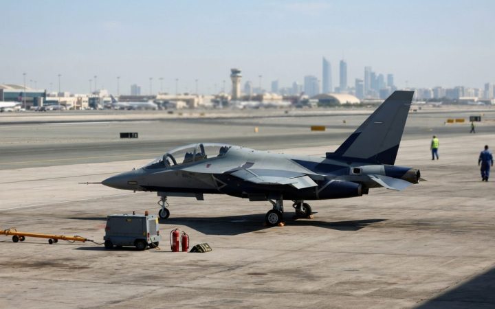 Illustration: A modern twin-engine advanced jet trainer aircraft painted in sleek display livery parked on an airfield tarmac under bright daylight, w