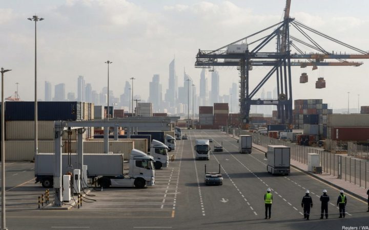 Illustration: A modern automated container logistics yard and electric commercial fleet charging depot with sleek transport vehicles, bathed in daytim