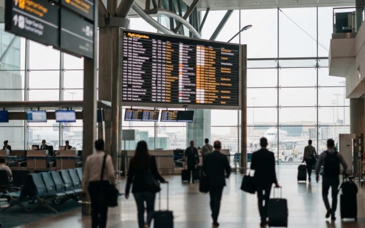 Illustration: Editorial photograph of an international airport flight information display terminal in the Middle East showing departure and arrival li