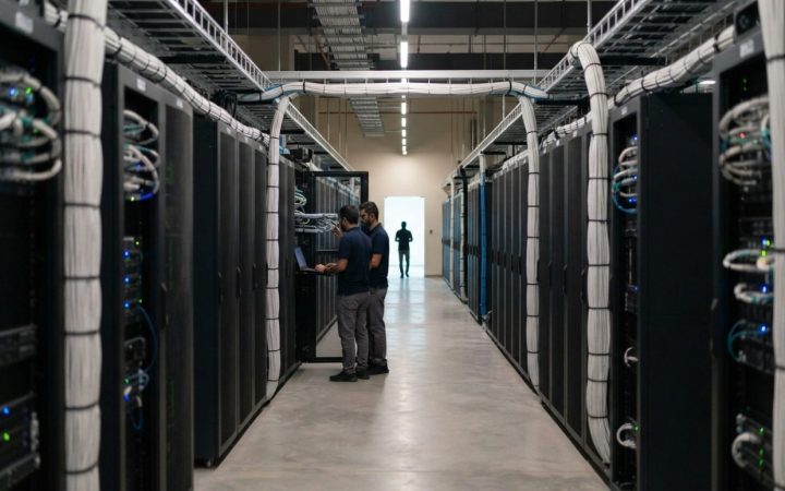 Illustration: A modern advanced artificial intelligence data center with long corridors of glowing server racks and structured optical cabling in the